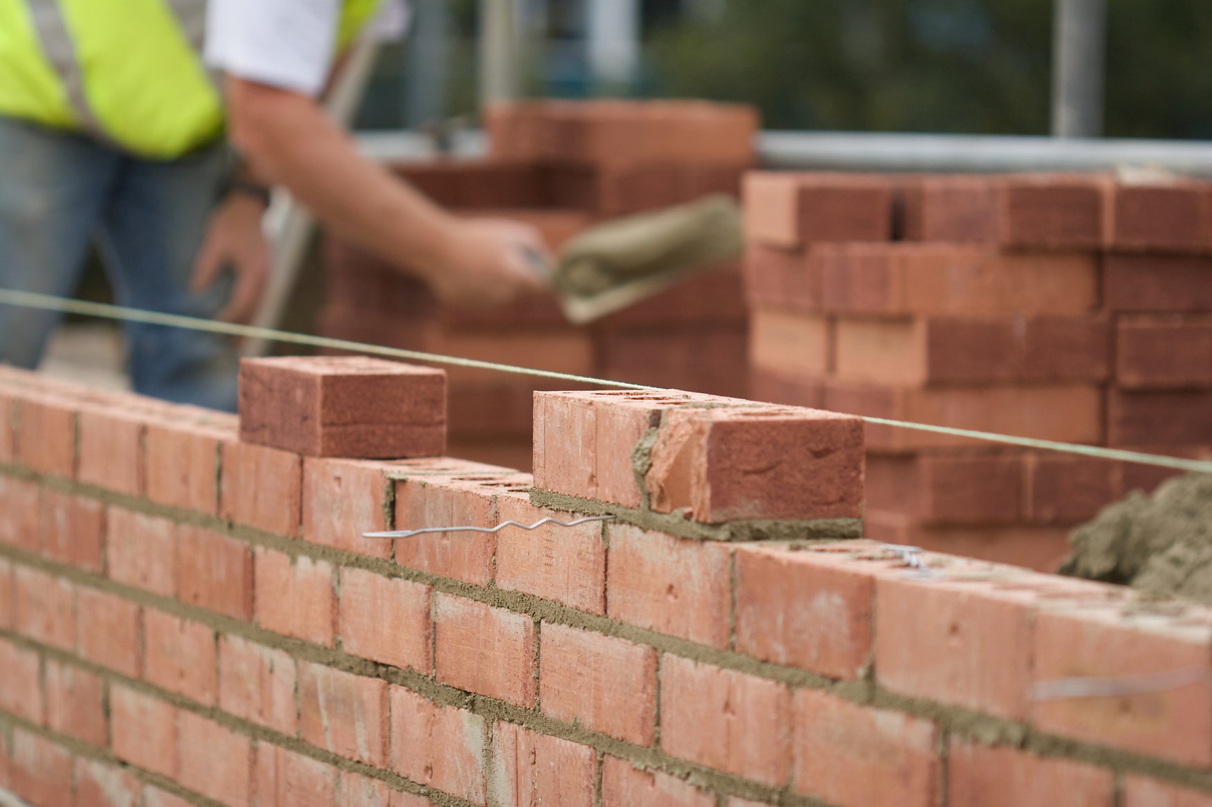 Bricklayer Laying Bricks On Site
